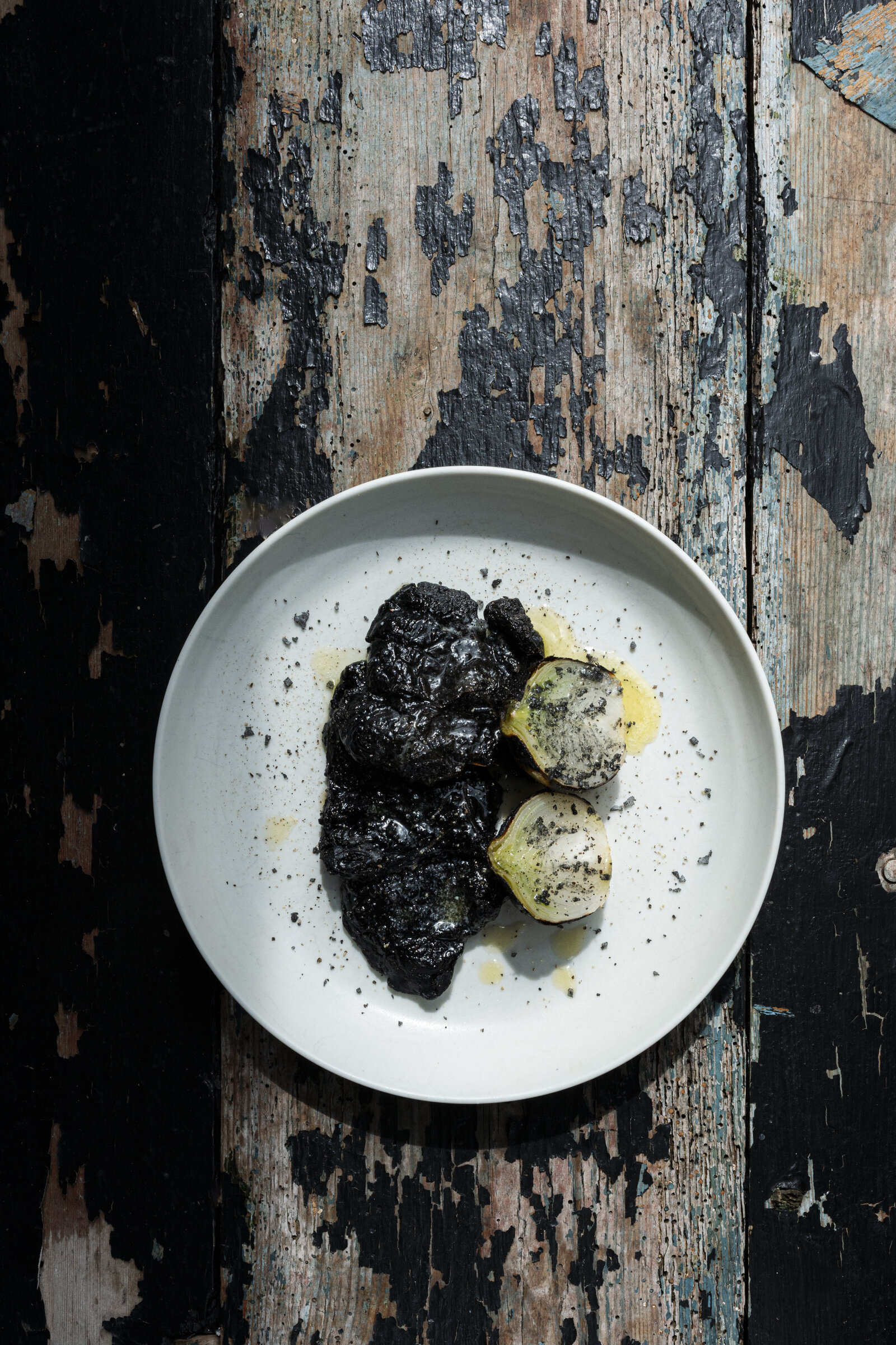 Grilled giant polypore with ember onions and lava salt